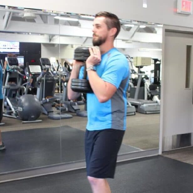 man performing goblet lunge 